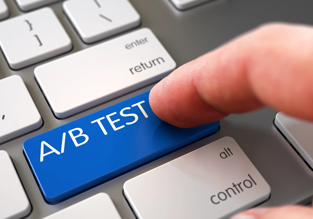 A person is pressing a blue button on a keyboard that says A/B Testing.