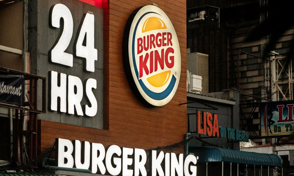 A Burger King sign on the side of a building.