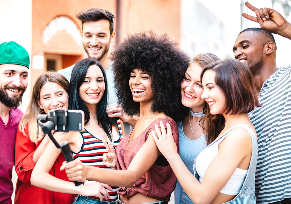 A group of friends taking a selfie, providing a social proof example.