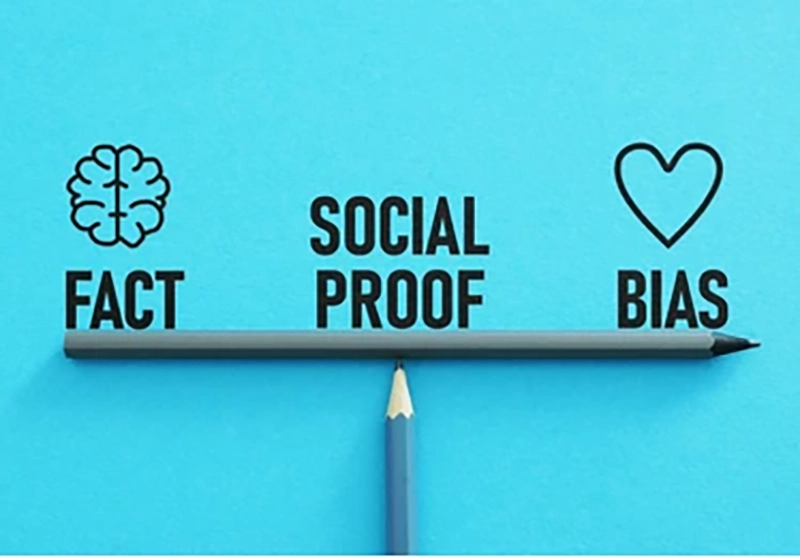 A pencil with the words "social proof" and "bias" engraved on it, representing the influence of social proof and bias in decision-making.