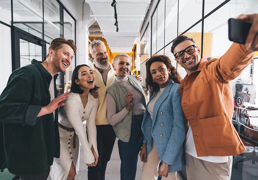 A group of people from an Influencer Marketing Agency taking a selfie in an office.