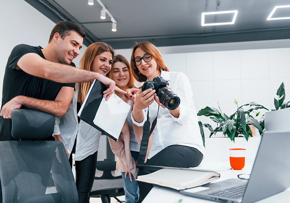 A group of people engaging with a camera in an office for an Influencer Marketing Agency.