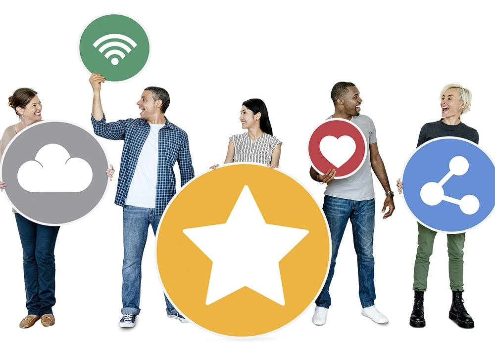 A group of people demonstrating social proof by holding up social media icons.