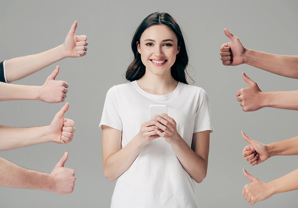 Young woman giving thumbs up as social proof in front of a group of people.