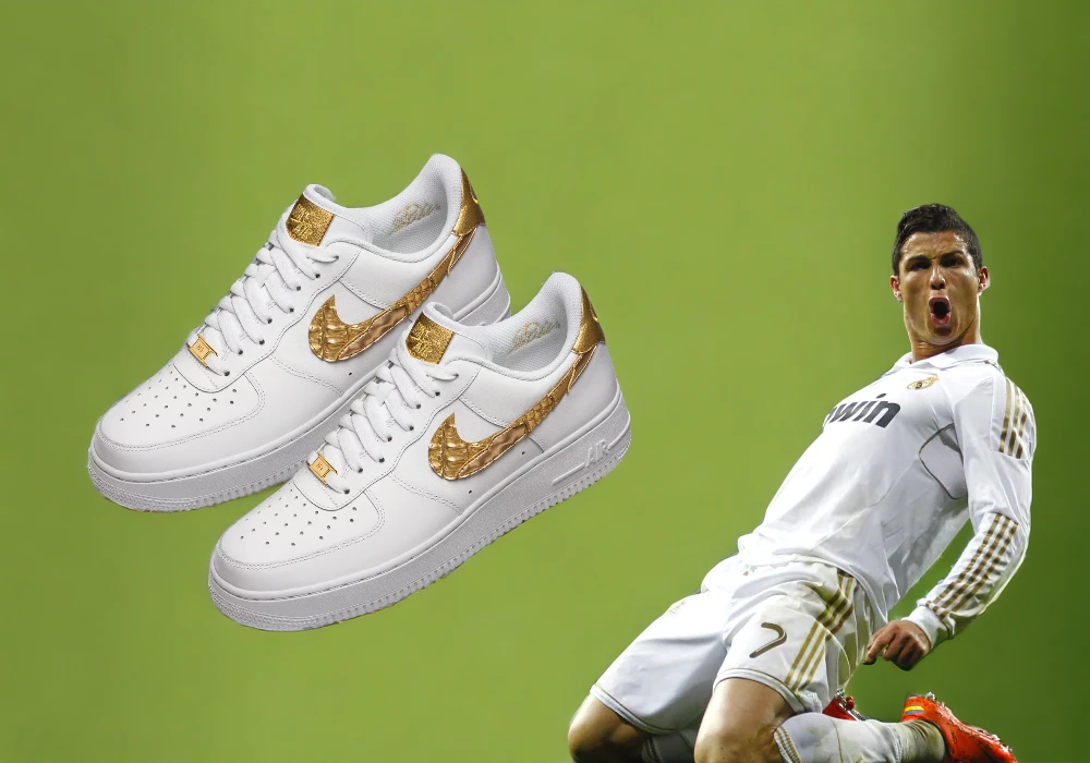 Two white Nike sneakers with golden details float above an image of a celebrity soccer player Cristiano Ronaldo in a white uniform against a green background.