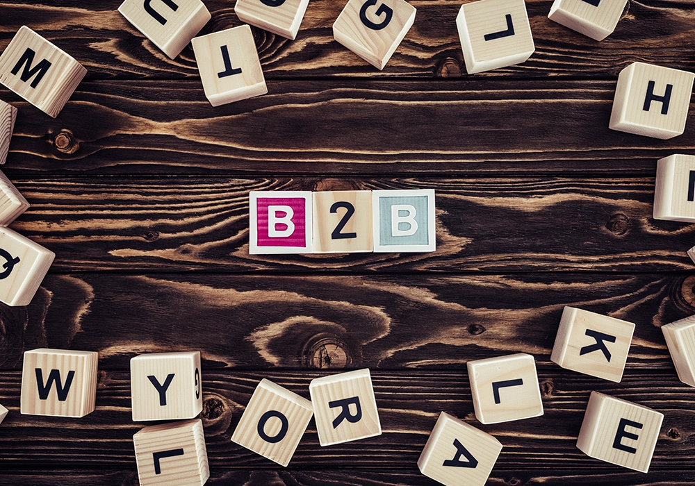 Wooden blocks scattered on a table with some organized to spell "B2B Marketing Agencies" in colorful letters at the center.