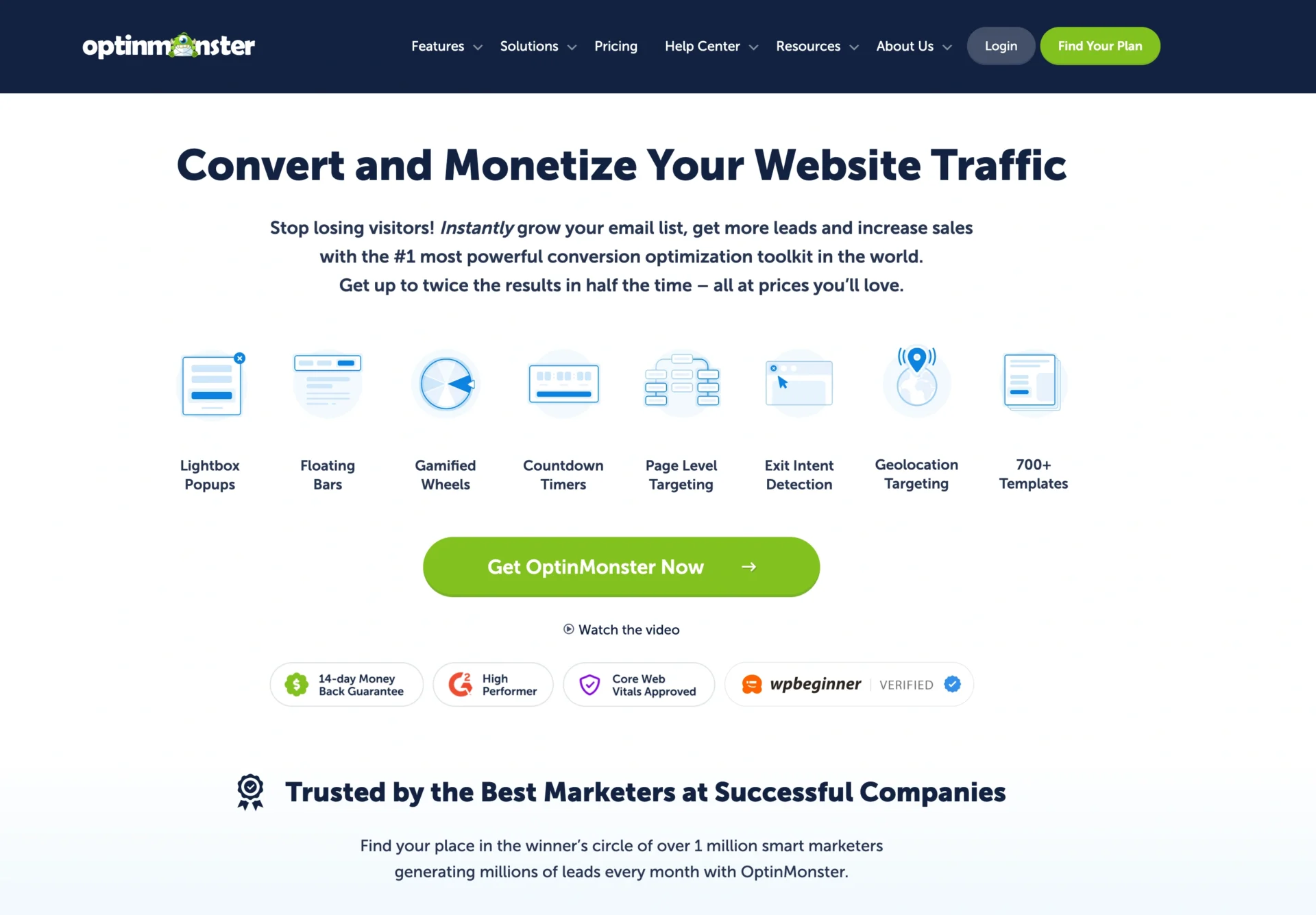 OptinMonster homepage featuring a headline on converting website traffic, fomo tools, a green call-to-action button, feature icons, and trust badges from well-known companies and review sites.