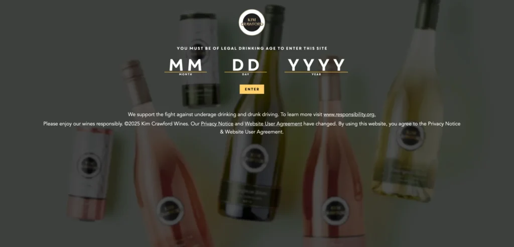 A splash page example featuring a blurred background of wine bottles, this landing page prompts users to enter their date of birth for age verification before accessing the main site.