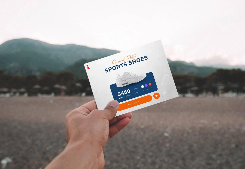 A hand holds a postcard with an advertisement for sports shoes priced at $450, featuring a "Buy Now" button—an eye-catching splash page example set against a blurred outdoor background.